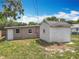 Exterior view of the home's backyard with shed and back entrance, perfect for storage and backyard access at 221 Golden Days Dr, Casselberry, FL 32707