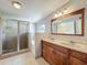 Bathroom features a double sink vanity, separate shower and tub with tiled floors at 221 Golden Days Dr, Casselberry, FL 32707