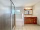 Bathroom features a double sink vanity, separate shower and tub with tiled floors at 221 Golden Days Dr, Casselberry, FL 32707