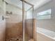 Shower with glass enclosure and neutral tiling alongside soaking tub at 221 Golden Days Dr, Casselberry, FL 32707