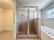 Bathroom featuring glass-enclosed shower, tub and tile flooring at 221 Golden Days Dr, Casselberry, FL 32707