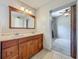 Bathroom vanity with wood cabinets, double sinks, and large mirror in a well-lit space at 221 Golden Days Dr, Casselberry, FL 32707