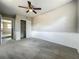 Serene bedroom featuring a ceiling fan, carpeted floor, and closet, creating a cozy sanctuary at 221 Golden Days Dr, Casselberry, FL 32707
