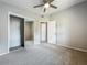 Bedroom features a ceiling fan, neutral carpeting and gray walls and closet at 221 Golden Days Dr, Casselberry, FL 32707