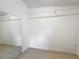 Empty closet space with white walls and light tile flooring and mirror at 221 Golden Days Dr, Casselberry, FL 32707