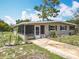 Lovely single-story home featuring a screened in porch, a charming front yard and a cozy curb appeal at 221 Golden Days Dr, Casselberry, FL 32707