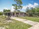 A well-kept single-story house with a concrete driveway and a lawn, creating a welcoming exterior at 221 Golden Days Dr, Casselberry, FL 32707