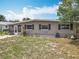 Single-story home with front lawn and a white picket fence, exuding a cozy, neighborhood charm at 221 Golden Days Dr, Casselberry, FL 32707