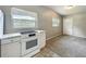 Open floorplan with kitchen featuring a white stove and ample natural light creating a welcoming atmosphere at 221 Golden Days Dr, Casselberry, FL 32707