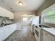 Bright kitchen featuring a functional layout with white cabinetry and essential appliances, ready for your culinary adventures at 221 Golden Days Dr, Casselberry, FL 32707