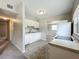 Well-lit kitchen features white cabinets and flows into adjacent rooms offering a convenient and functional layout at 221 Golden Days Dr, Casselberry, FL 32707
