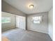 Bright living room with ample natural light, comfortable carpeting, and convenient front door access at 221 Golden Days Dr, Casselberry, FL 32707