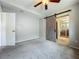 Bedroom featuring a ceiling fan, gray walls and a decorative barn door to the bathroom at 221 Golden Days Dr, Casselberry, FL 32707