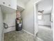 Utility room with water heater and neutral color palette leading into the home at 221 Golden Days Dr, Casselberry, FL 32707