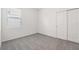 A cozy bedroom showcasing plush carpeting, a window with blinds, and a convenient closet at 2502 Linda Knoll Ln, Bartow, FL 33830
