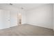 Bright, carpeted bedroom featuring a door to the bathroom at 2502 Linda Knoll Ln, Bartow, FL 33830