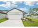 Charming single-Gathering home featuring a two-car garage, well-manicured lawn, and welcoming front porch at 2502 Linda Knoll Ln, Bartow, FL 33830
