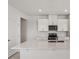 Modern kitchen with white cabinets, stainless steel appliances, and a spacious center island at 2502 Linda Knoll Ln, Bartow, FL 33830