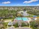 Aerial view of the community pool, clubhouse, playground and surrounding neighborhood at 2528 Double Tree Pl, Oviedo, FL 32766