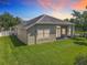 The back of the house has a spacious lawn and a covered patio, perfect for enjoying the outdoors at 2528 Double Tree Pl, Oviedo, FL 32766