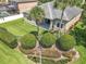 Aerial view of a well-manicured backyard featuring lush lawn, mature landscaping, and a covered patio at 2528 Double Tree Pl, Oviedo, FL 32766