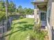 This grassy, fenced backyard features a covered patio and lush landscaping at 2528 Double Tree Pl, Oviedo, FL 32766