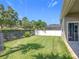 A well-maintained backyard with green grass and black metal fence, perfect for outdoor activities at 2528 Double Tree Pl, Oviedo, FL 32766