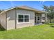 Home's exterior features a lush lawn, mature landscaping, and a covered patio at 2528 Double Tree Pl, Oviedo, FL 32766