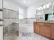 Bathroom featuring a walk-in shower, soaking tub, granite counters, and custom tile work at 2528 Double Tree Pl, Oviedo, FL 32766