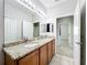 Bathroom boasts double vanity with granite countertops and ample storage with a view into the hall at 2528 Double Tree Pl, Oviedo, FL 32766