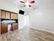 Bedroom with built-in desk/cabinet, ceiling fan, neutral walls, and wood-look flooring at 2528 Double Tree Pl, Oviedo, FL 32766
