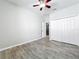 Bedroom with closet doors, ceiling fan, light gray walls, and wood-look flooring at 2528 Double Tree Pl, Oviedo, FL 32766
