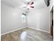 Bedroom features ceiling fan, wood-look flooring, and window letting in natural light at 2528 Double Tree Pl, Oviedo, FL 32766