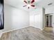 Bedroom with closet doors, ceiling fan, light gray walls, and wood-look flooring at 2528 Double Tree Pl, Oviedo, FL 32766