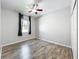 Bright bedroom features a ceiling fan, wood-look flooring and large windows with plenty of natural light at 2528 Double Tree Pl, Oviedo, FL 32766