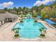 An aerial view of a community pool with slides, cabanas and plenty of lounging chairs at 2528 Double Tree Pl, Oviedo, FL 32766