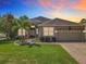 Charming single-story home featuring a well-manicured lawn, tropical landscaping, and a paved driveway at 2528 Double Tree Pl, Oviedo, FL 32766