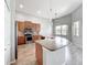 Modern kitchen featuring stainless appliances, wood cabinets, granite countertops and breakfast bar at 2528 Double Tree Pl, Oviedo, FL 32766