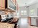 Modern kitchen features stainless steel appliances, mosaic backsplash, and granite countertops at 2528 Double Tree Pl, Oviedo, FL 32766