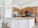 Spacious kitchen with granite countertops, stainless steel appliances, mosaic backsplash and wood cabinets at 2528 Double Tree Pl, Oviedo, FL 32766
