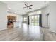 Open floor plan with hardwood floors, large windows, and slider doors to outside at 2528 Double Tree Pl, Oviedo, FL 32766