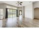 Spacious living room with hardwood floors, ceiling fan, and sliding glass doors to backyard at 2528 Double Tree Pl, Oviedo, FL 32766