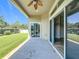 Covered patio with ceiling fan overlooking a lush, fenced backyard with mature landscaping and a sliding glass door at 2528 Double Tree Pl, Oviedo, FL 32766
