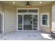 Covered patio area, featuring a ceiling fan and access to the lush fenced backyard and sliding glass doors at 2528 Double Tree Pl, Oviedo, FL 32766