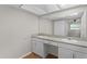 Bathroom with a double sink vanity, a large mirror and wood floors at 2666 Derbyshire Rd, Maitland, FL 32751