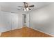Bright bedroom features a ceiling fan, wood floors, and closet for ample storage space at 2666 Derbyshire Rd, Maitland, FL 32751