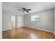 Bedroom boasts wood floors, a ceiling fan and a window offering natural light at 2666 Derbyshire Rd, Maitland, FL 32751