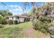Charming single-story home with a well-manicured lawn and mature trees providing shade at 2666 Derbyshire Rd, Maitland, FL 32751