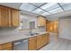 Bright kitchen featuring wood cabinetry, stainless steel dishwasher, and a double basin sink at 2666 Derbyshire Rd, Maitland, FL 32751