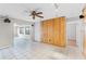 Living area with tile floors, paneled wall, and access to the kitchen at 2666 Derbyshire Rd, Maitland, FL 32751